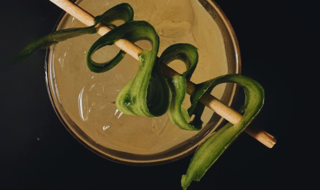 Close up of teeling cocktail with cucumber ribbon